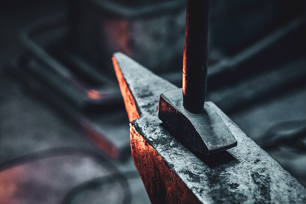 Hammer and anvil at dark smith workshop